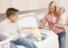 Laundry Mother Helping Son Washing Machine Baby Chores 30s 7 Year Old Assistance Assisting Boy Casual Clothing Caucasian Cheerful Child Cleaning Color Colour Domestic Elementary Age Family Holding Home Horizontal Housework Image Indoors Laundry Basket Mid